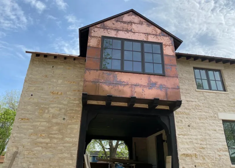 Copper metal panel facade on a stone building for Skylight Installation in Lucerne Valley